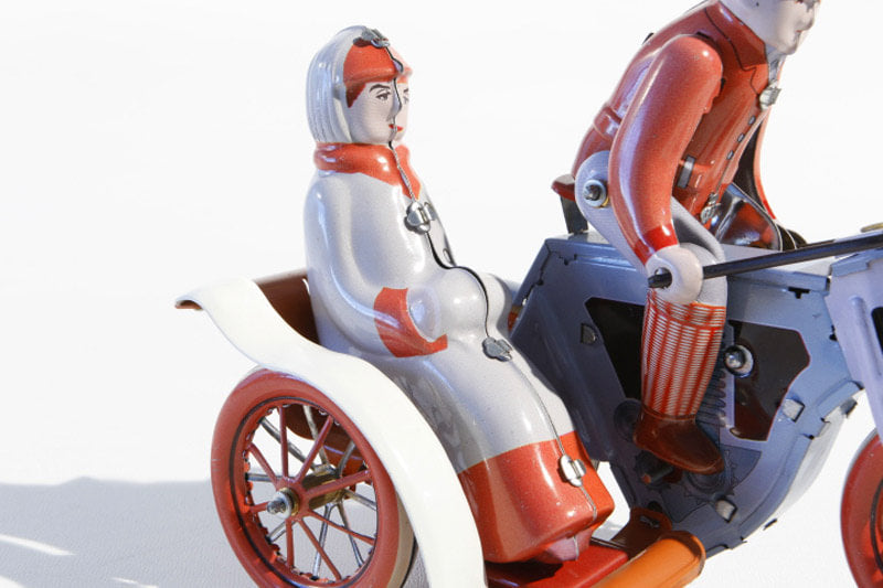 Close up of Vintage Motorcycle with Side Car tin toy with rider and passenger