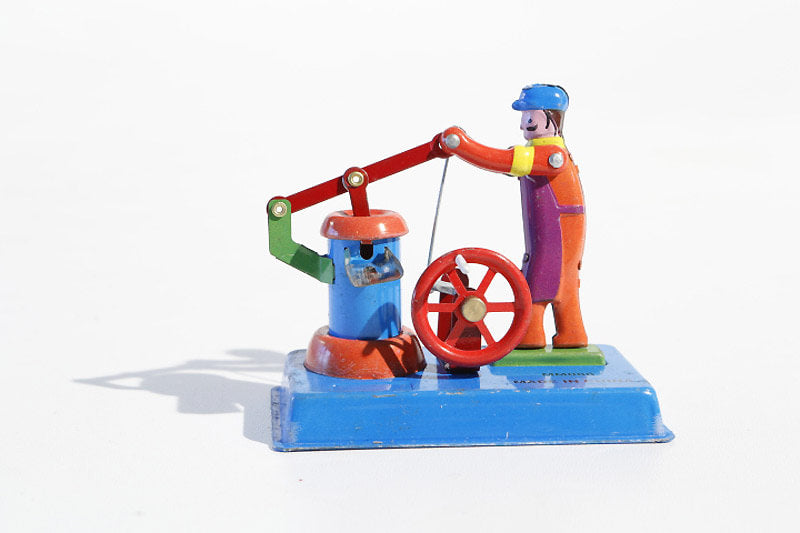 Water well tin toy 