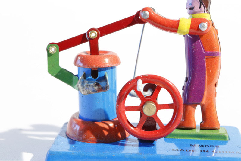Close up of Water well tin toy